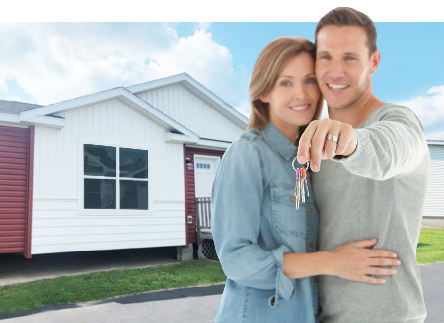 new home buyer couple holding house keys in front of manufactured home